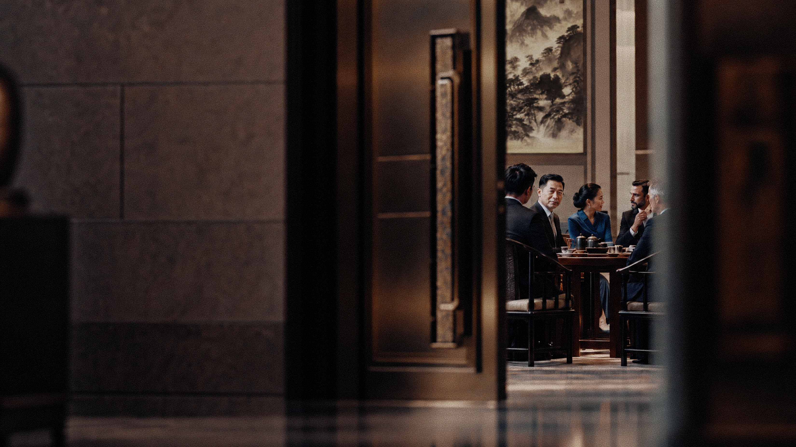 A private business dinner in China, seen through an open doorway